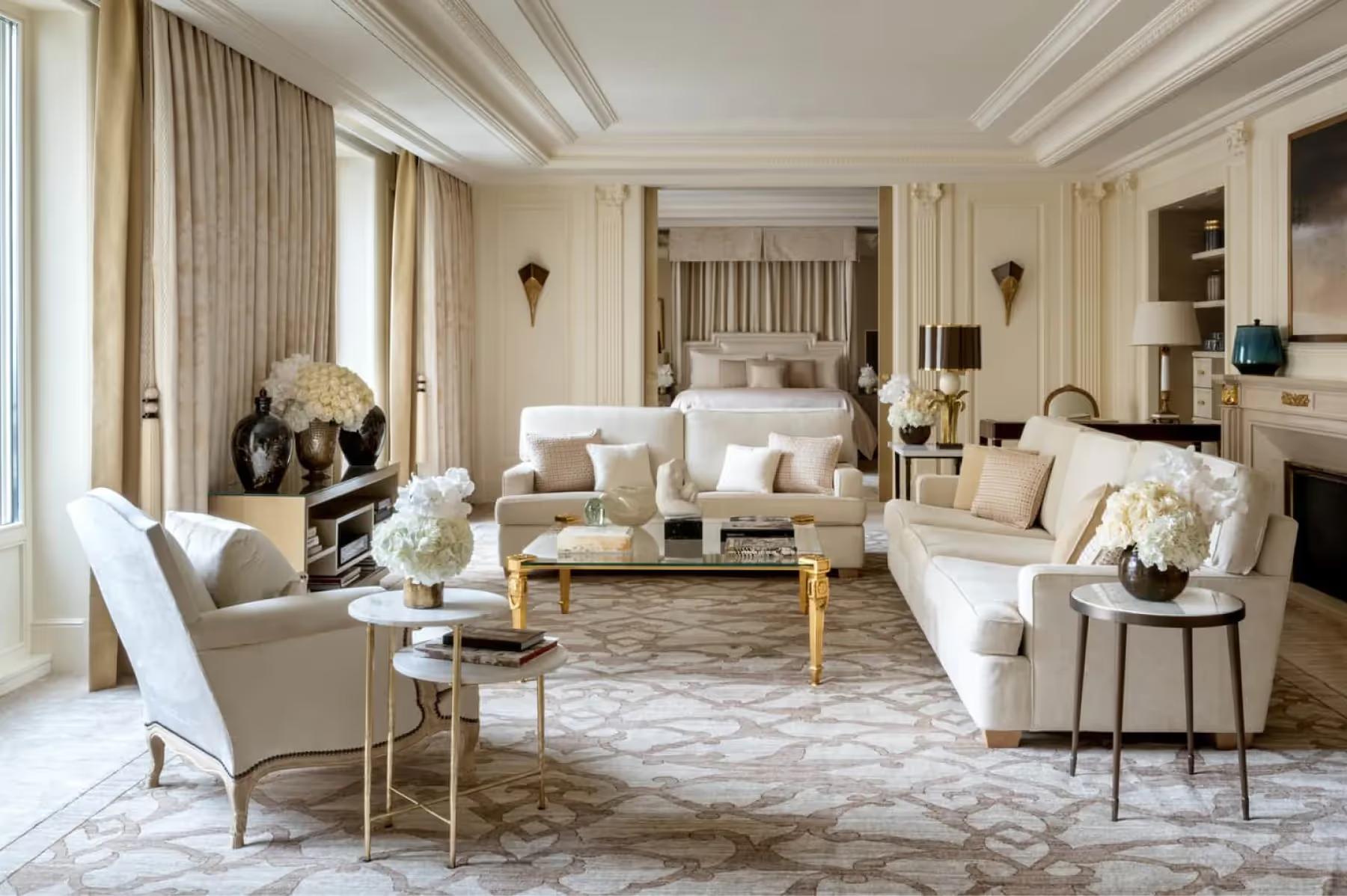 Four Seasons Hotel George V: a cream and beige suite with layered window treatments and a marble fireplace
