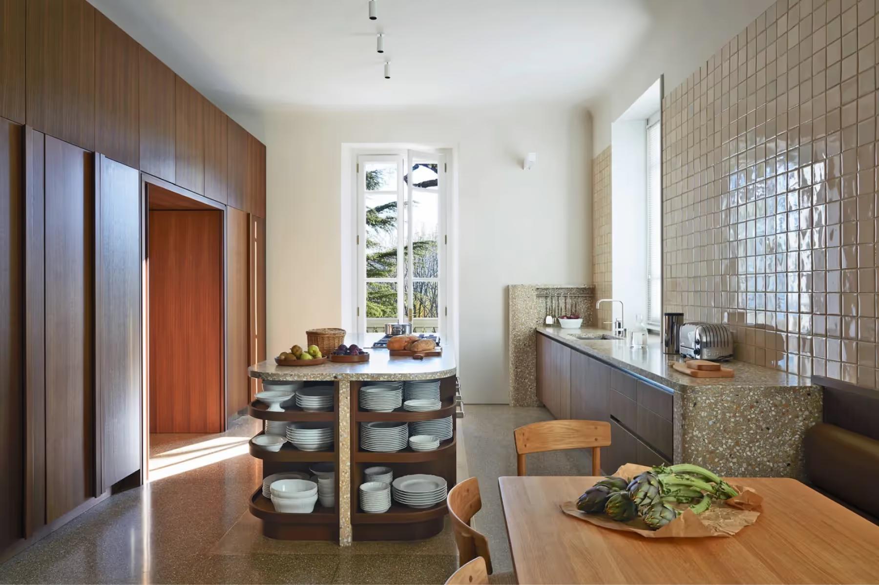 Villa Patrizia: a kitchen workspace with tiled backsplash and marble cooking island
