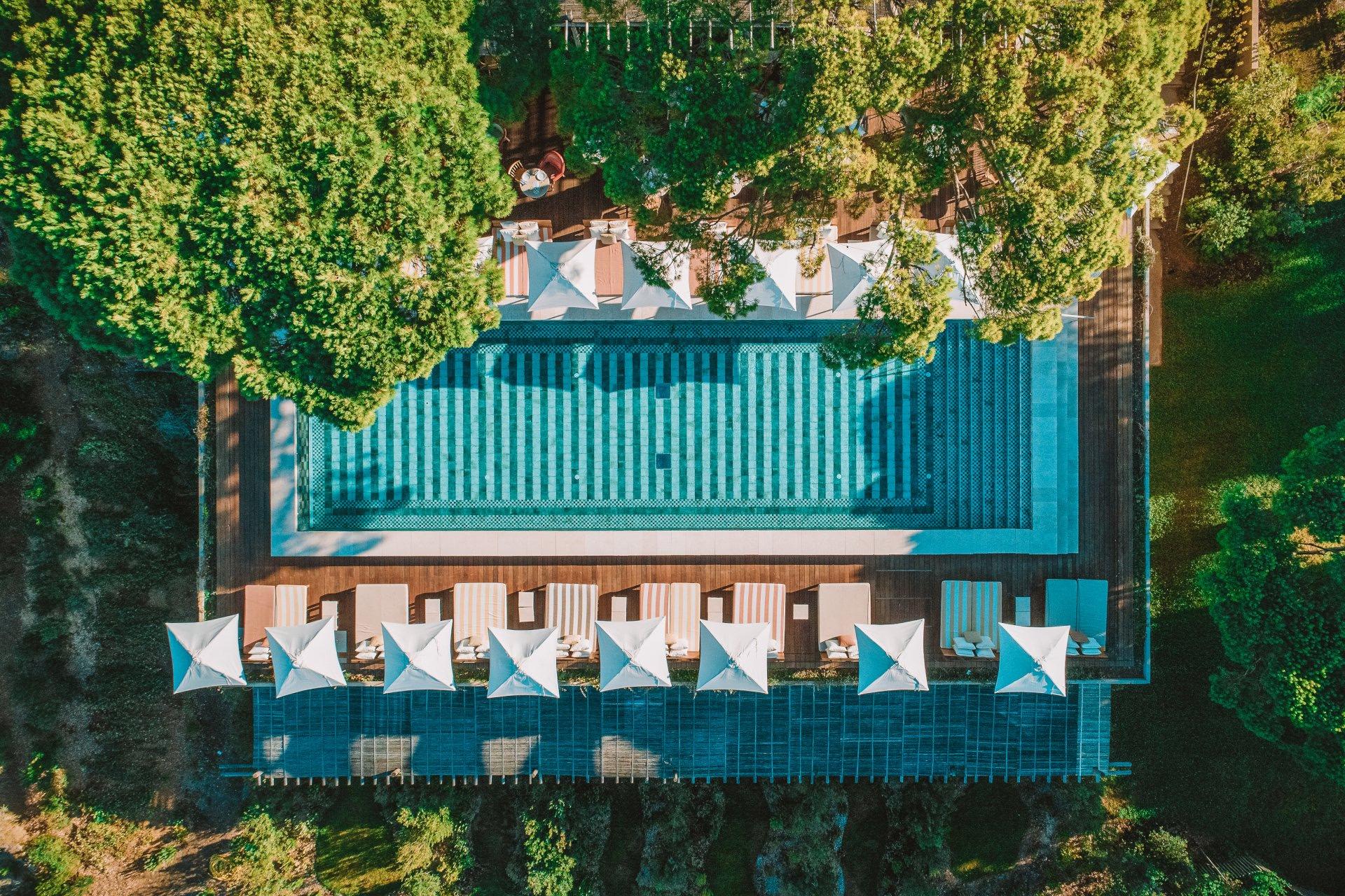 Lily of the Valley: aerial view of pool and sunbeds set in forested hillside
