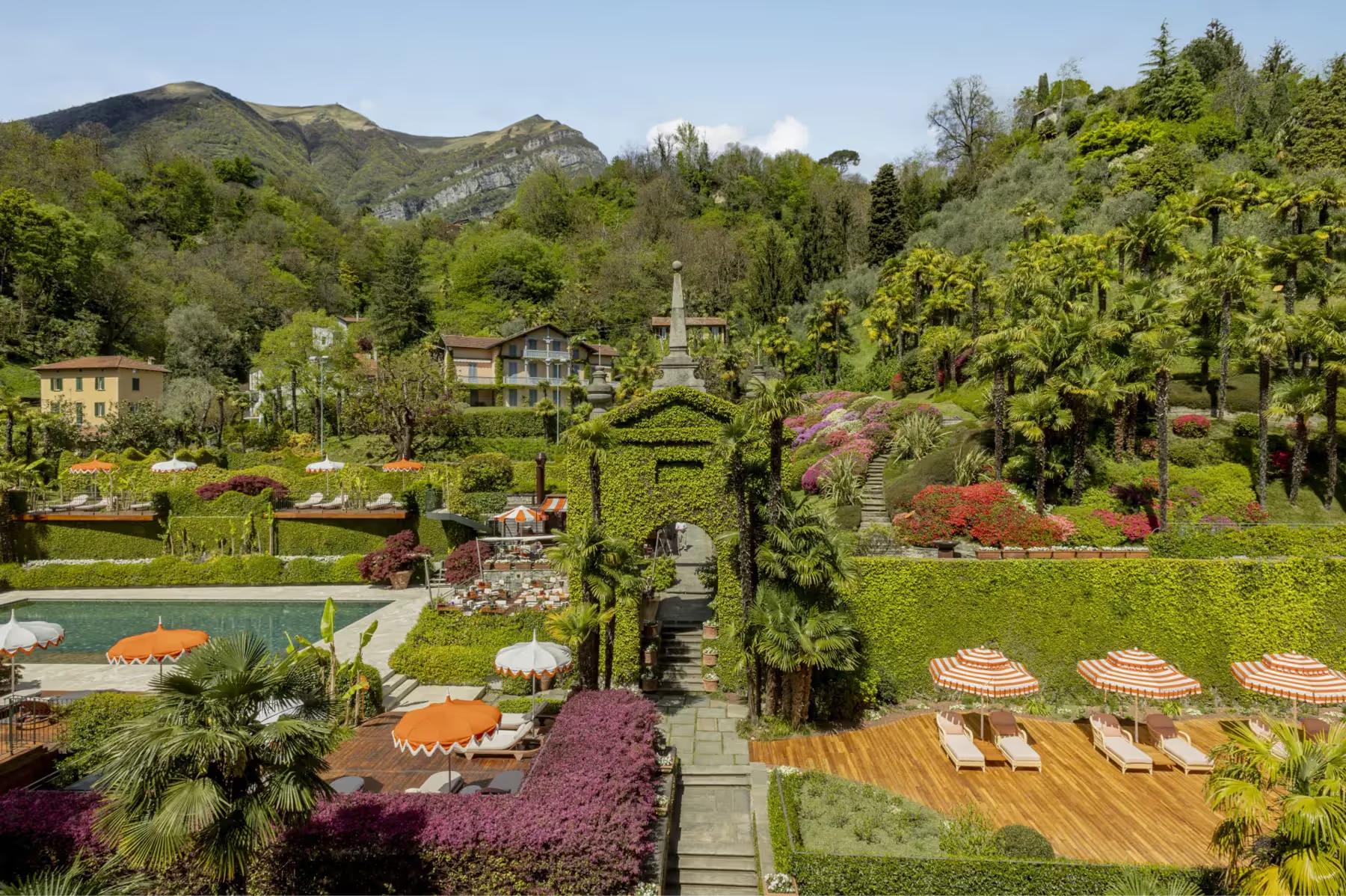 Grand Hotel Tremezzo: manicured gardens with flowering beds, a pond, and hotel buildings set in green hills