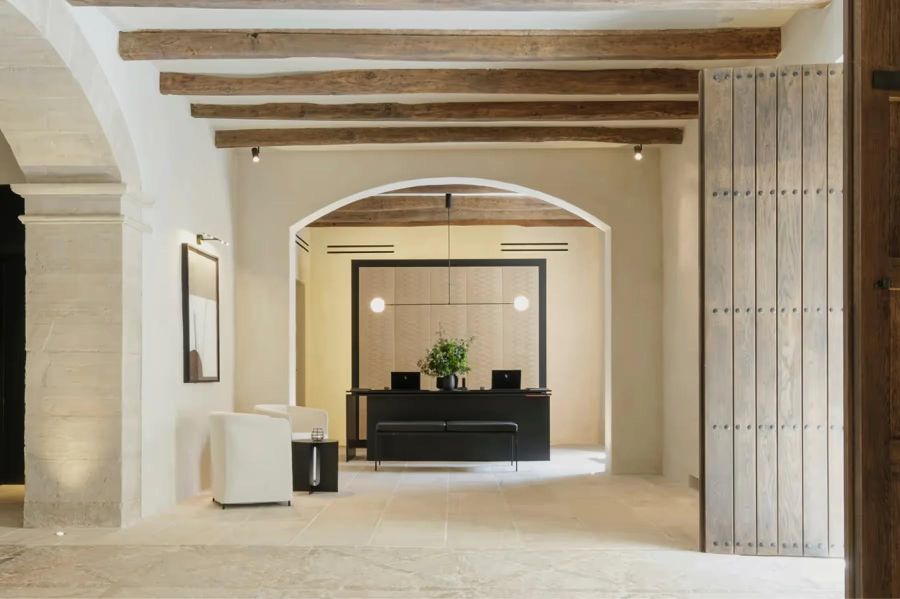 Interior archways with wooden beams framing view through multiple rooms
