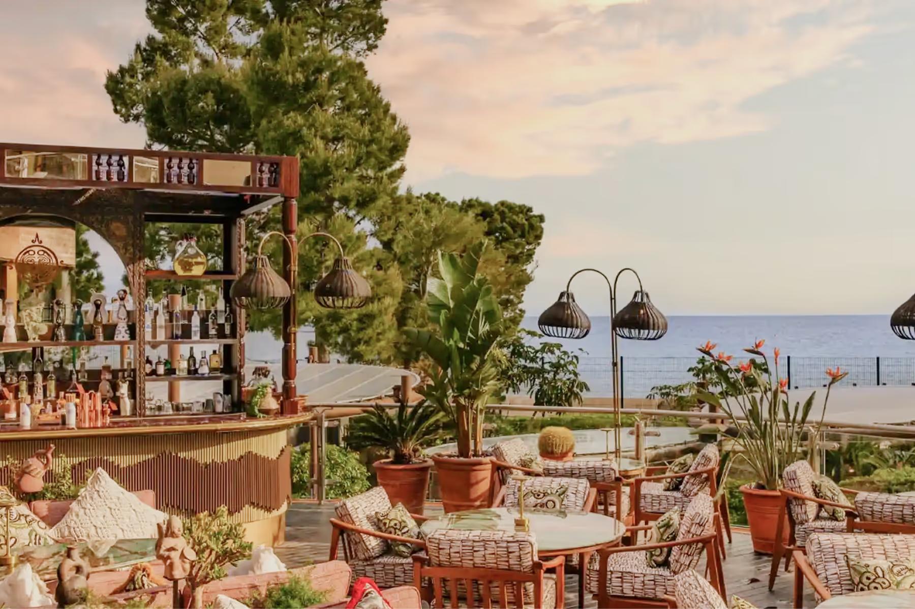 Hôtel de Paris Monte-Carlo: outdoor terrace restaurant with potted plants and tables facing the sea