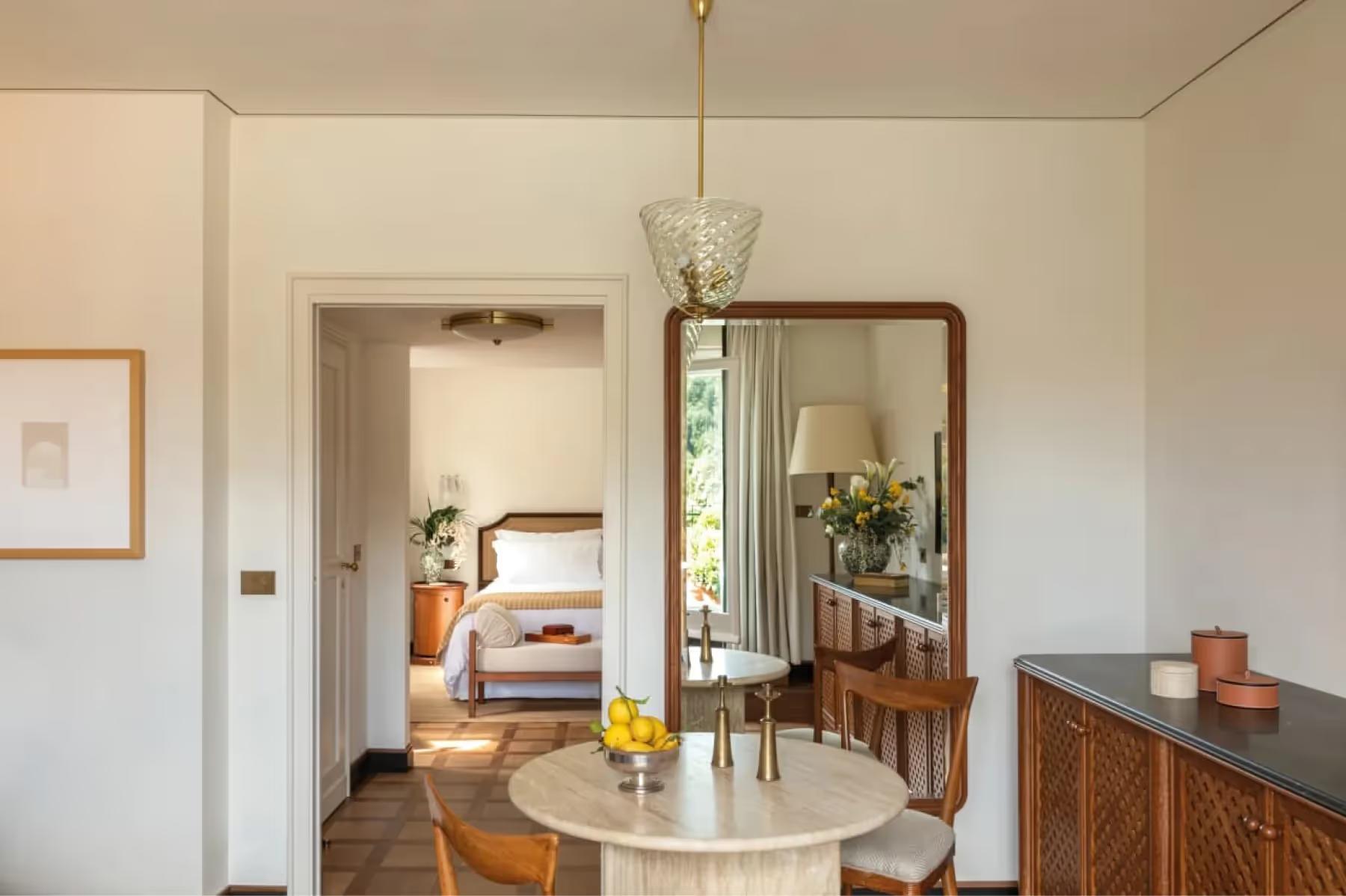 Suite with round mirror, seating, and harbor view
