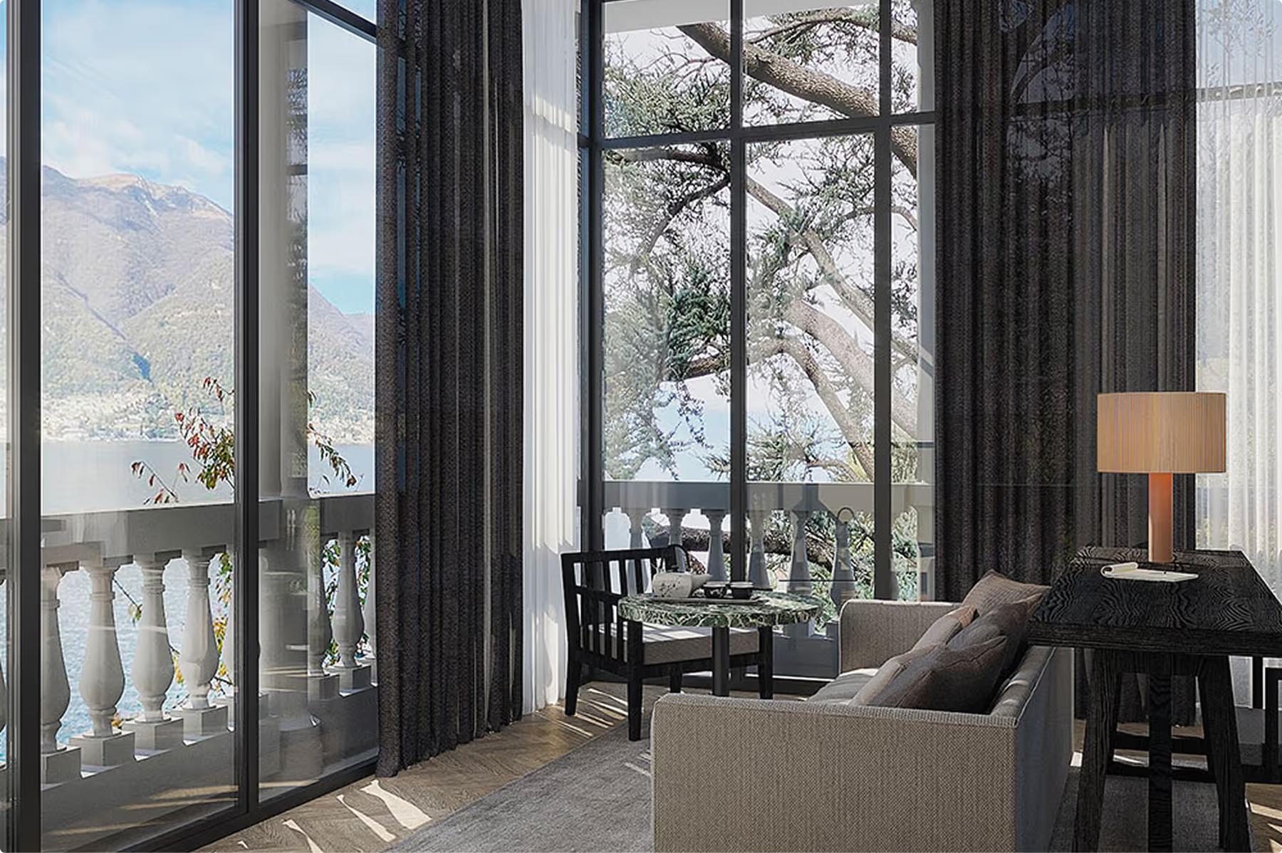 Suite with black drapery, gray seating, and expansive view to mountains and lake