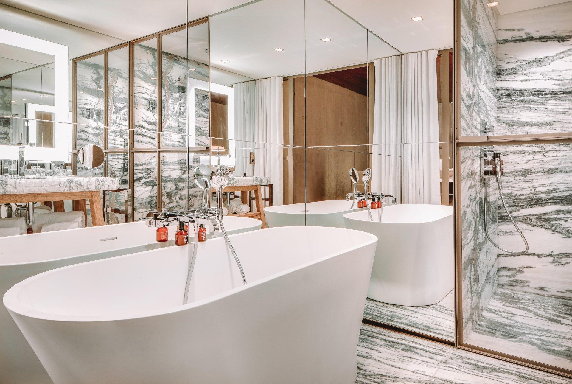 Lily of the Valley: spa bathroom with white soaking tub and mirrored wall accents