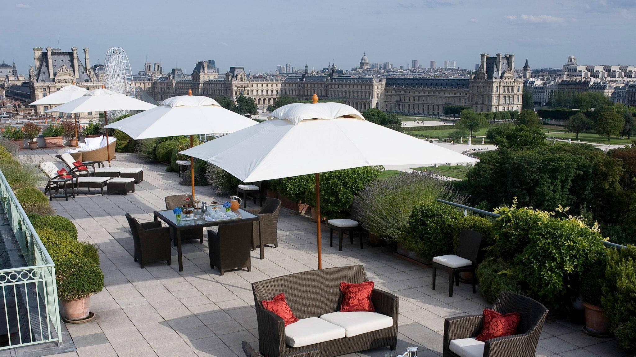 Le Meurice: the terrace area with shade structures and seating with Paris skyline views across the city