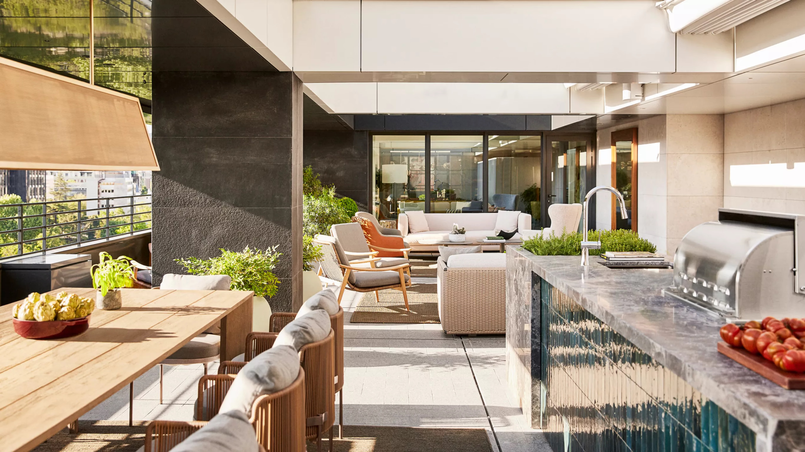Rosewood Villa Magna: an outdoor terrace with modern furniture, shade structure, and views into the hotel interior