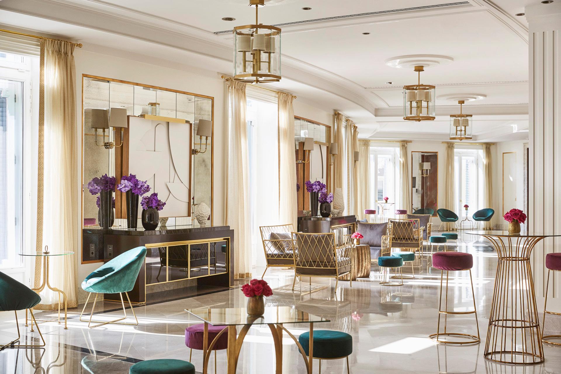 Four Seasons Hotel Madrid: mirrored spa gallery with white and marble finishes, brass fixtures, and ambient side lighting