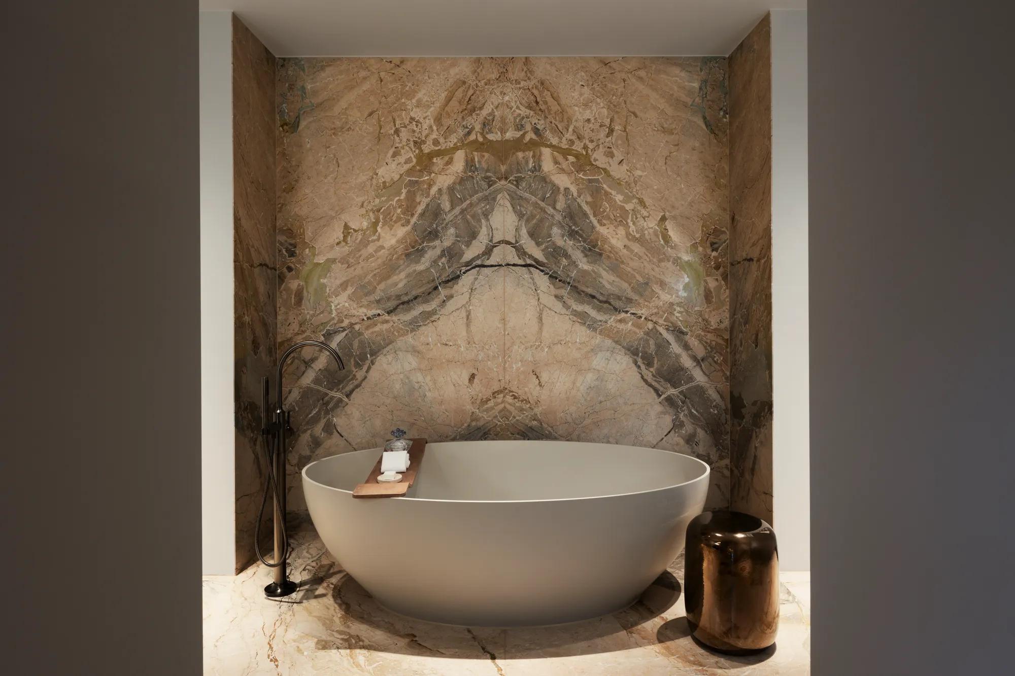 Rosewood Amsterdam: the Herengracht House bathroom with a freestanding tub in a marble niche