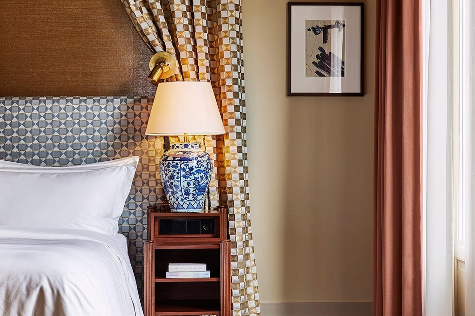 De L’Europe Amsterdam: bed with upholstered headboard, layered bedding, and bedside tables with lamps