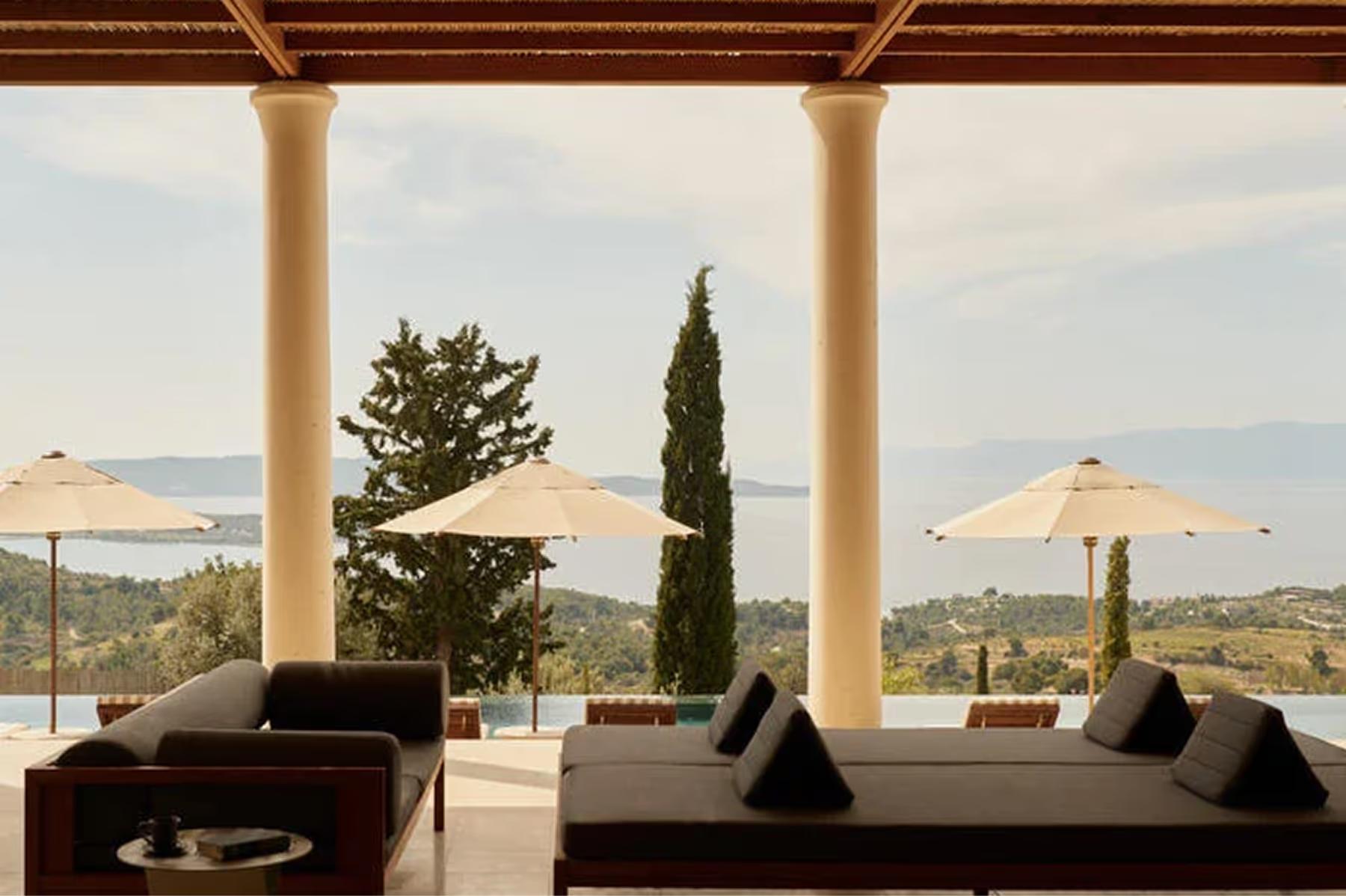 Amanzoe: sunset lounge terrace with stucco pergola and panoramic sea views