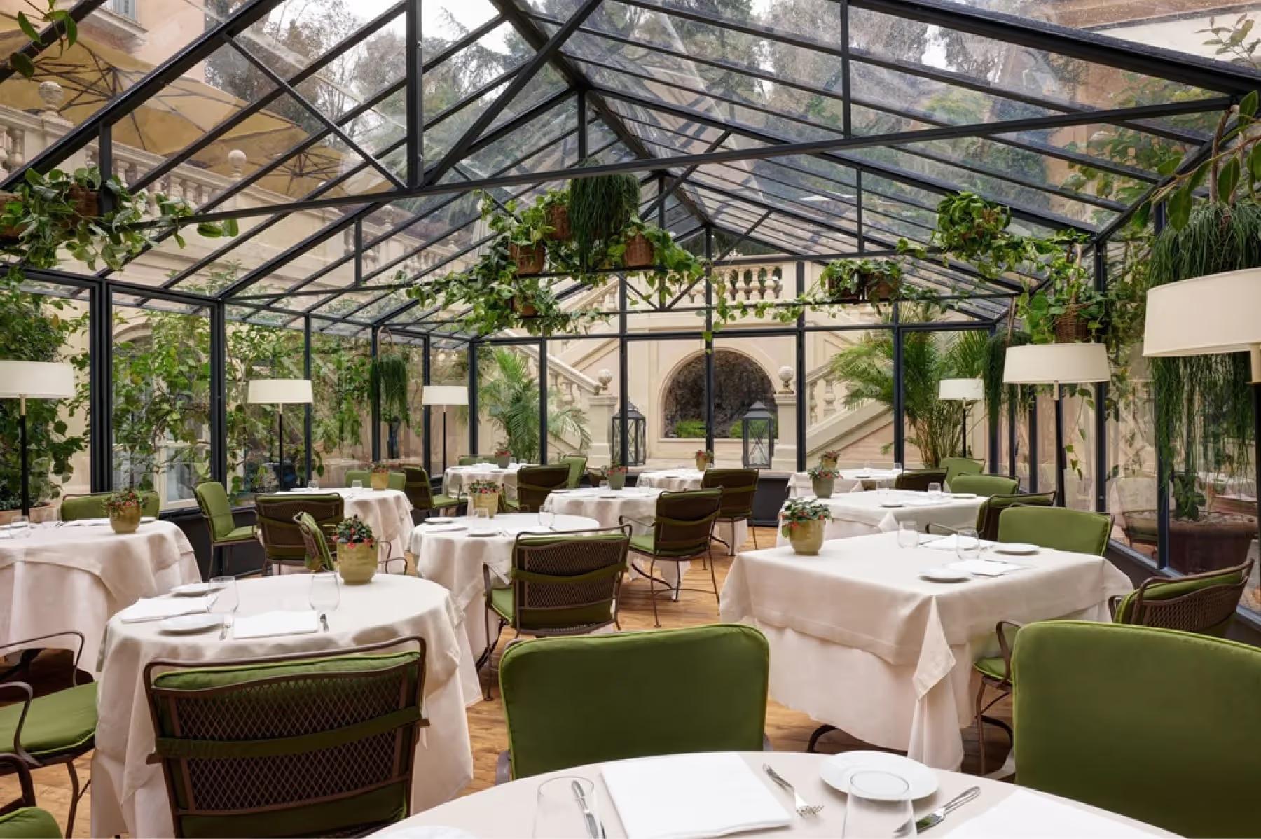 Hotel de Russie: glass conservatory dining room with arched ceilings and cream table settings