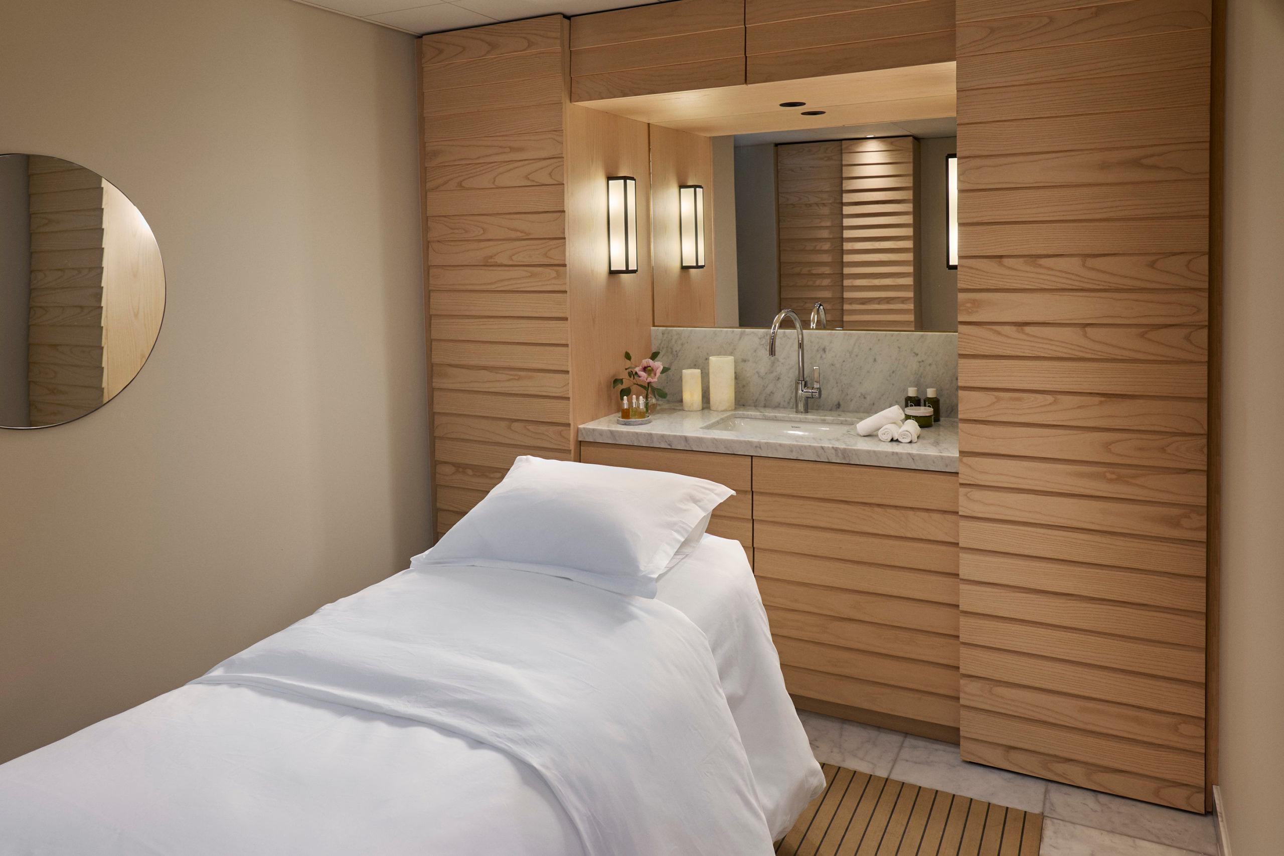 Villa Dagmar: wellness treatment room with wooden accents and spa massage bed