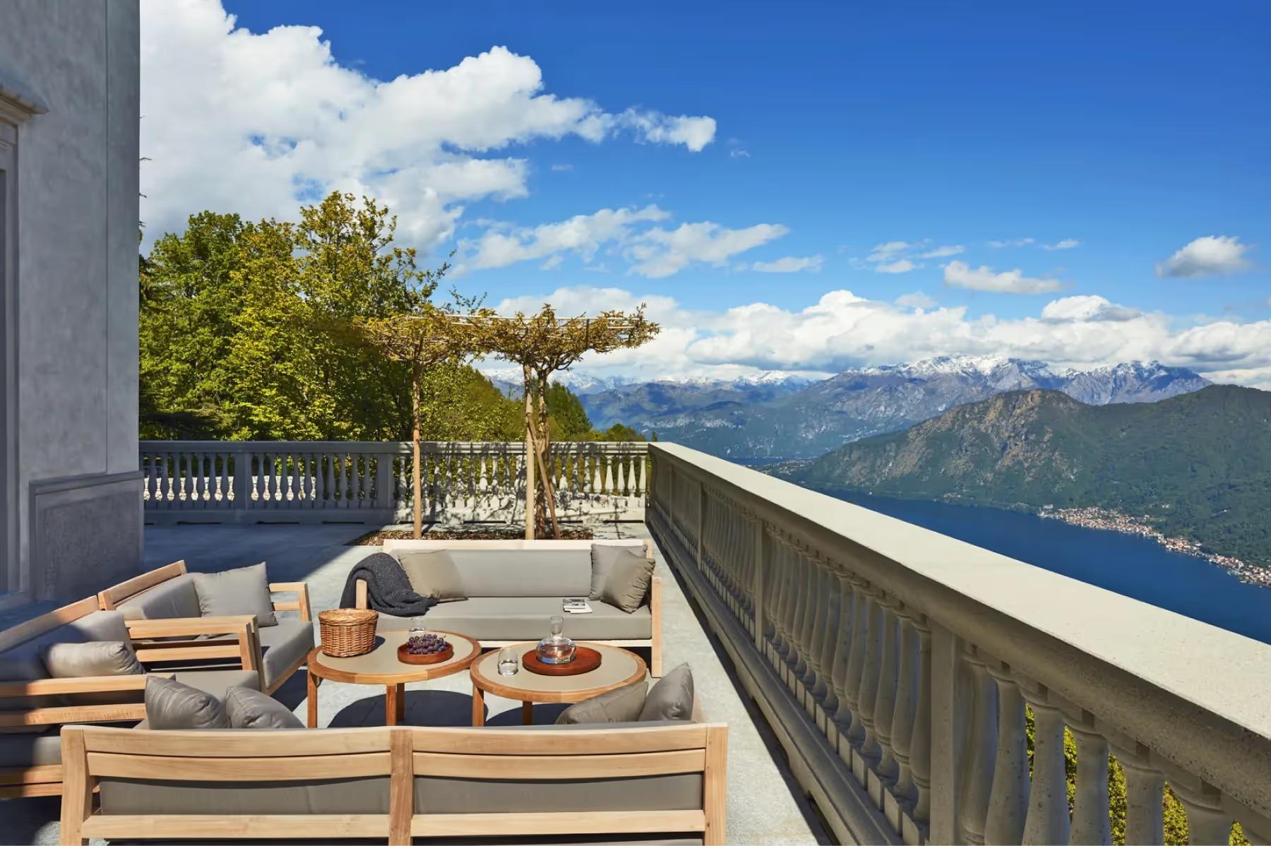 Villa Patrizia: a raised terrace with seating and views across Lake Como to distant mountains