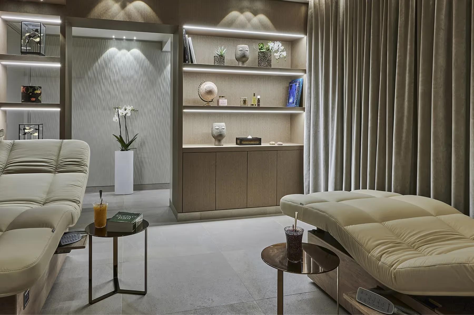 Spa relaxation lounge with cream seating and built-in shelving