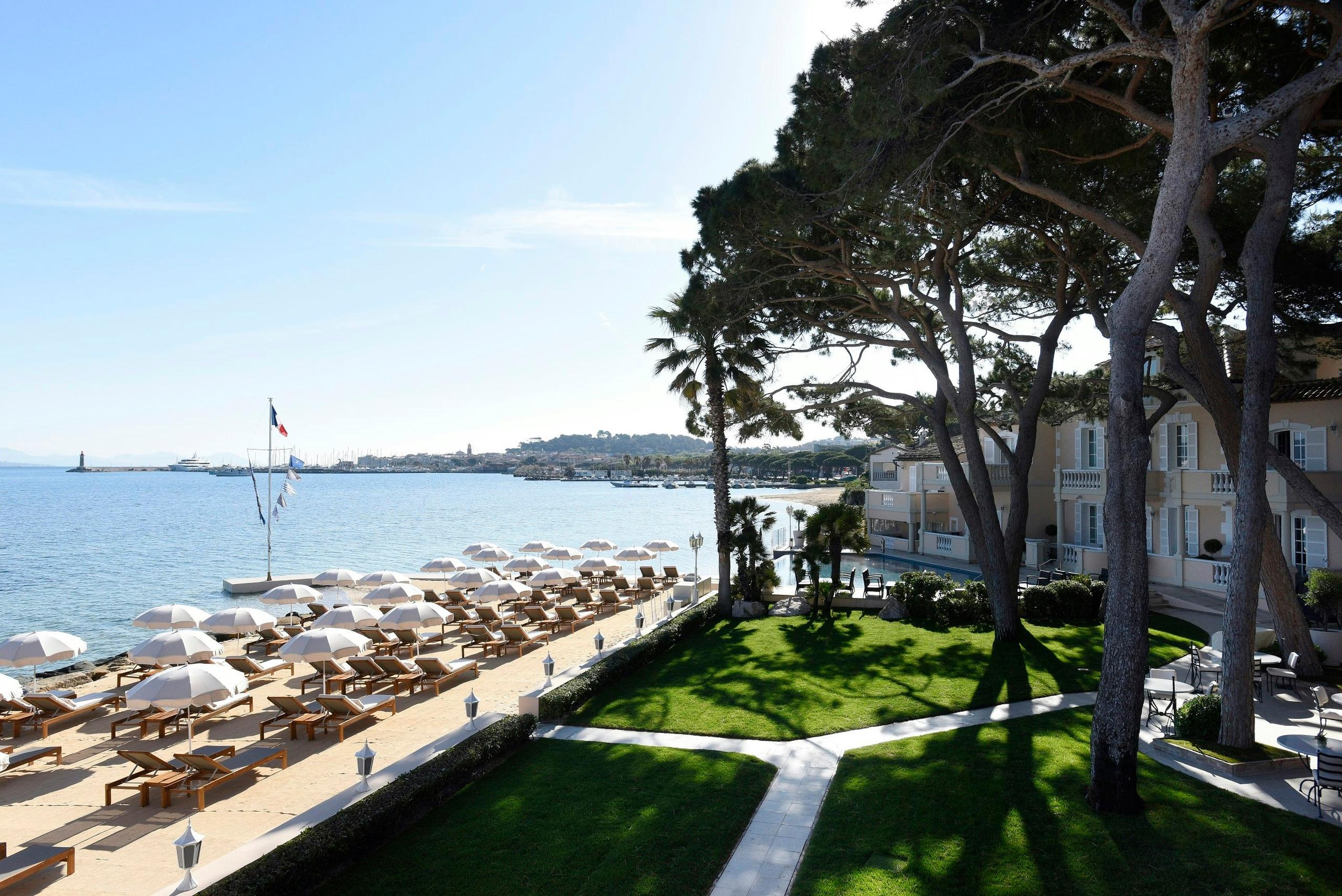 Cheval Blanc St-Tropez: beachfront lawn with pines and Mediterranean vista from the property