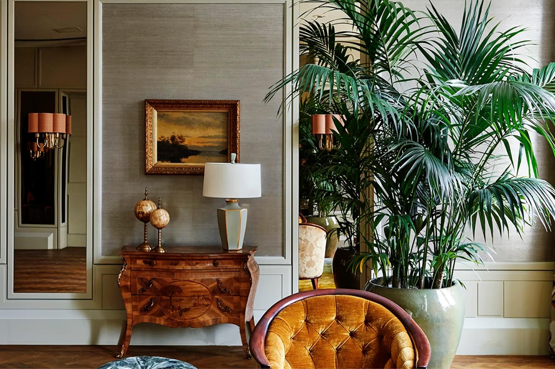 De L’Europe Amsterdam: foyer with botanical arrangement, wood furniture, and architectural detailing