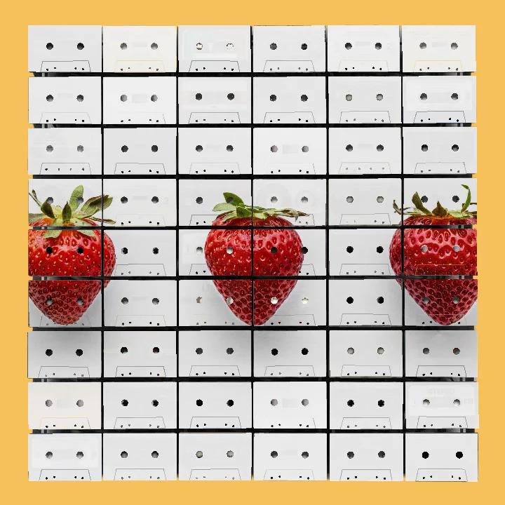 Three red strawberries spaced across a white cassette mosaic