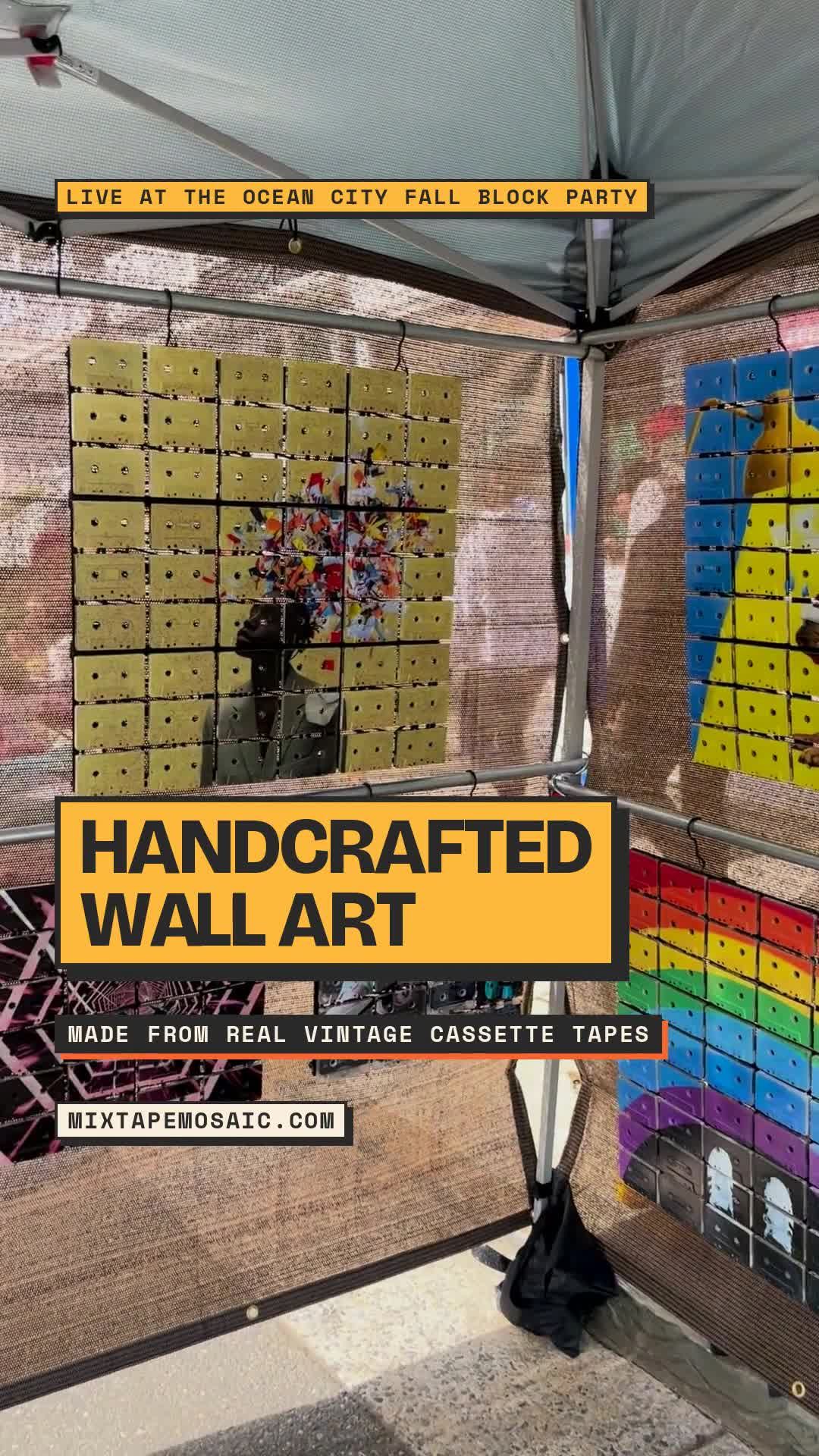 Several colourful Mixtape Mosaic cassette artworks displayed together on mesh walls beneath a canopy at the Ocean City Fall Block Party
