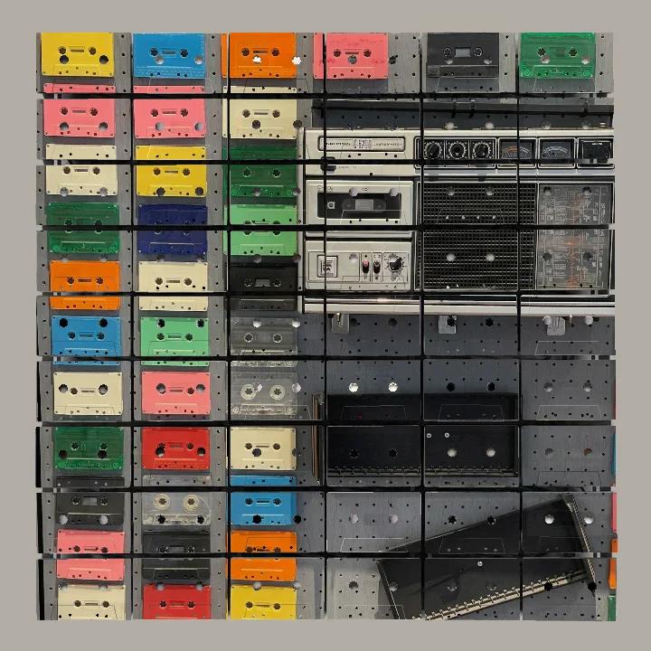 Studio artwork study of a boombox and coloured cassette collection spread across cassette faces