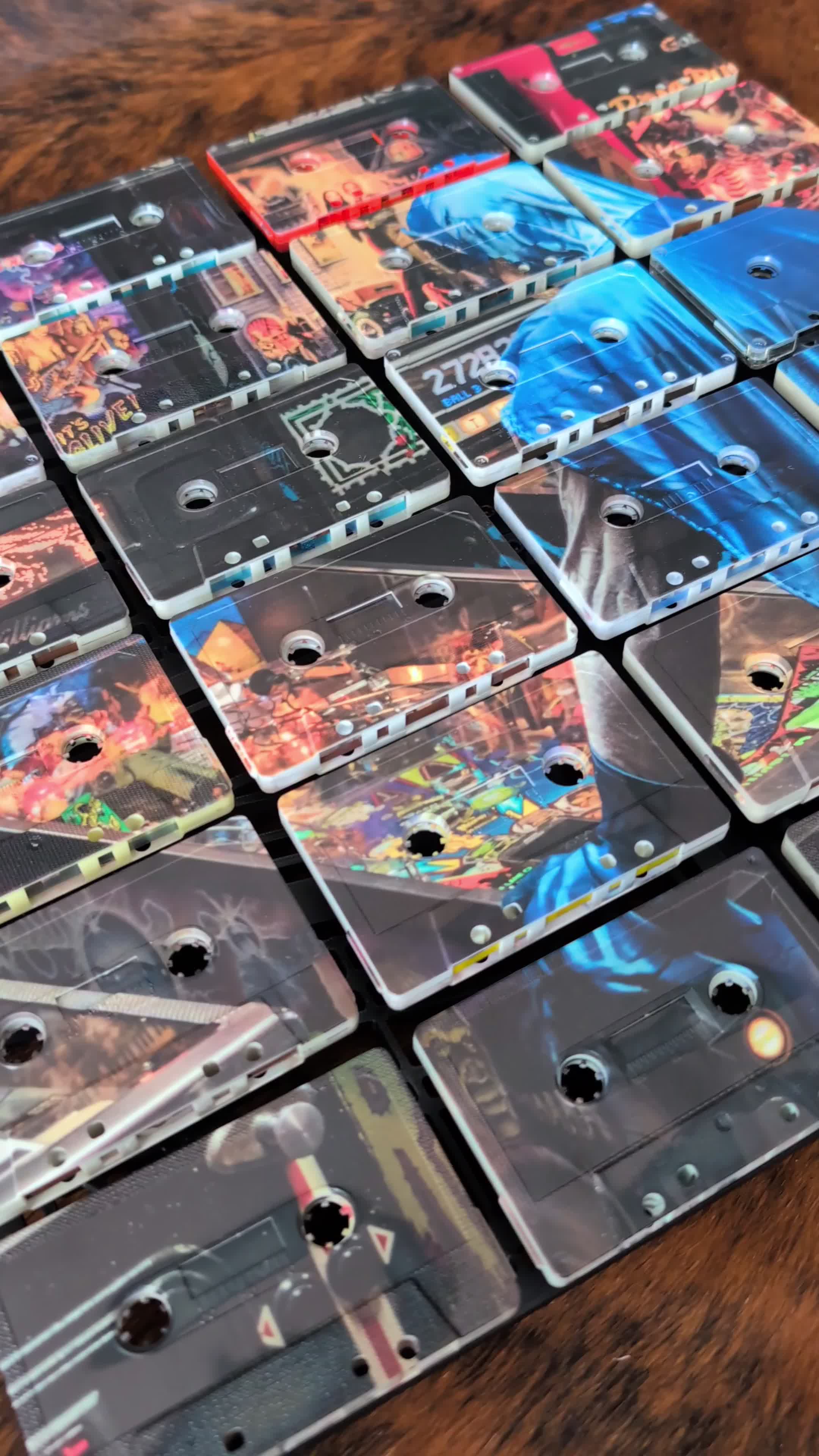 Close view of a finished cassette mosaic with blue, black and warm photographic passages crossing varied cassette faces