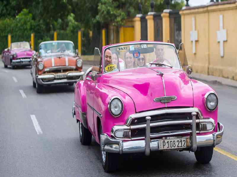 Cruise through Havana in classic 1950s convertibles, capturing the city’s iconic style and energy.
