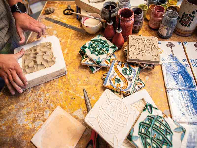 Discover Portugal’s vibrant culture through Lisbon’s colorful streets, traditional tile-making, and soulful Fado music.