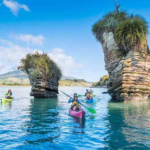 Scenic sea kayaking adventure in Raglan surrounded by stunning coastal landscapes and native forest views. Scenic sea kayaking adventure in Raglan surrounded by stunning coastal landscapes and native forest views.