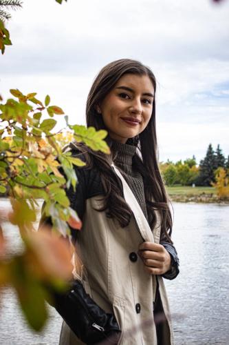 Girl by river during fall