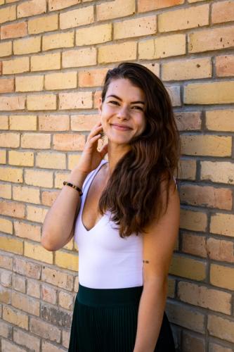 Girl against brick wall