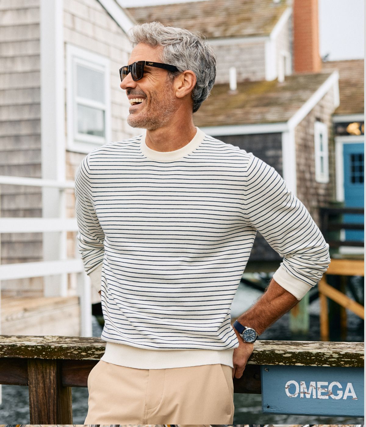 Man outside wearing the Pearl White Navy Stripe Ashe Crewneck Sweater.
