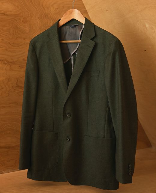 The Lavelle Blazer in dark green on a wooden hanger.