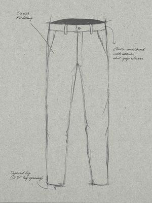 Technical pencil sketch of men's trousers on textured paper with annotations for "Stretch Pocketing", "Elastic waistband with interior shirt-grip silicone", and "Tapered leg (13 ½" leg opening)".