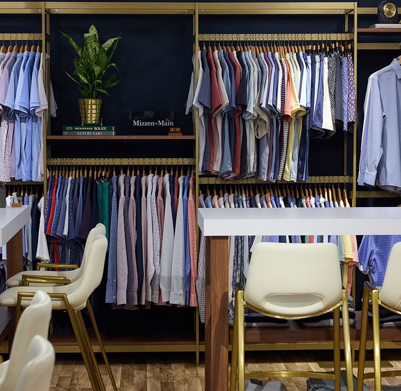 Racks of colorful Mizzen+Main dress shirts on display in the showroom.