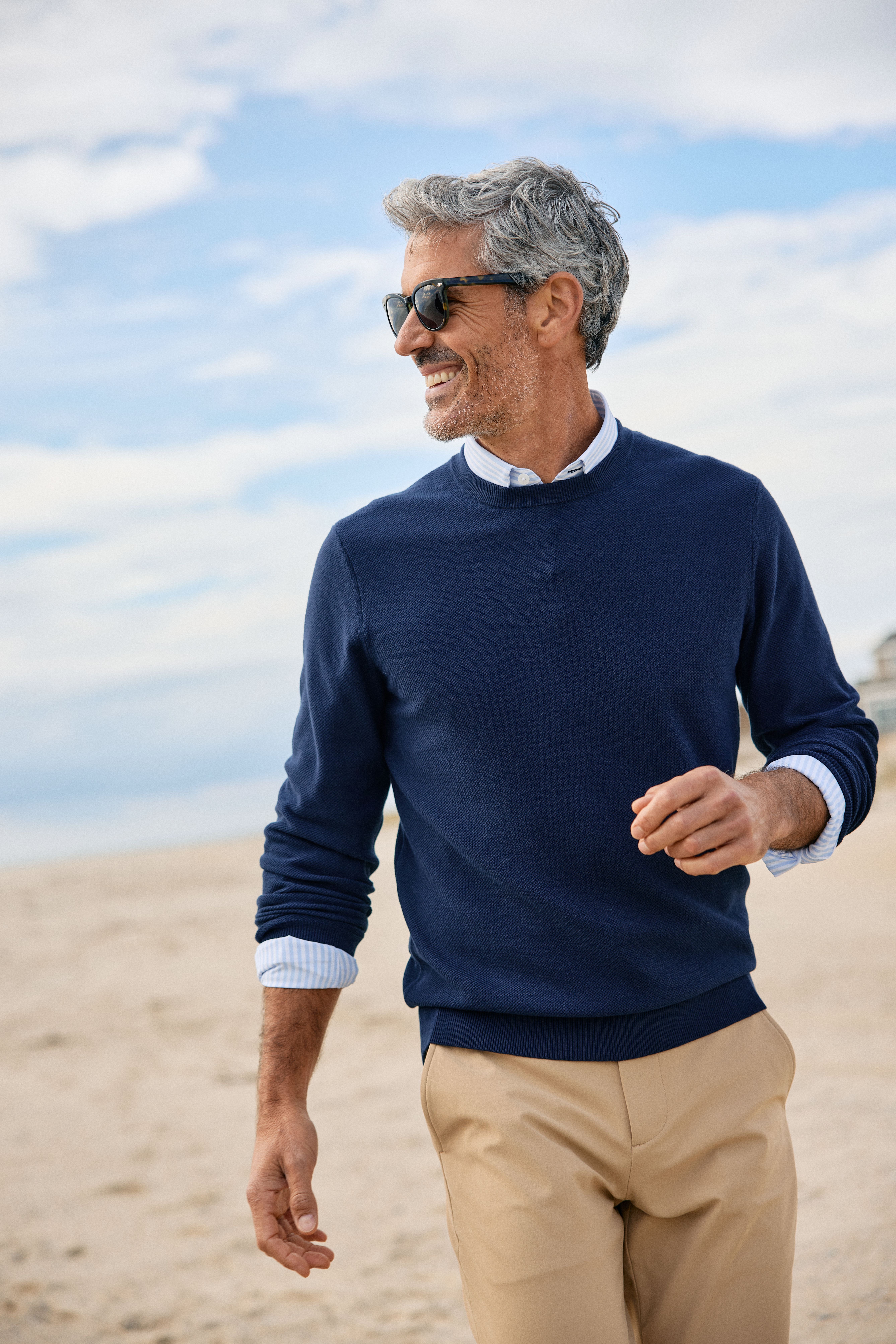 Man relaxing outside wearing the new Heritage sweater.