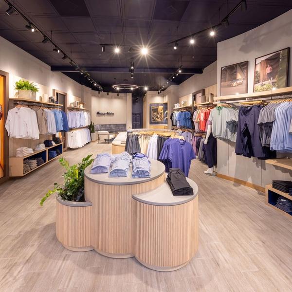 Interior of the Mizzen+Main West Village store with folded polos and racks of shirts