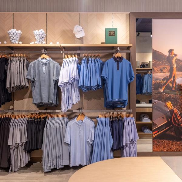 Wall display of polos and tees in the Mizzen+Main West Village store