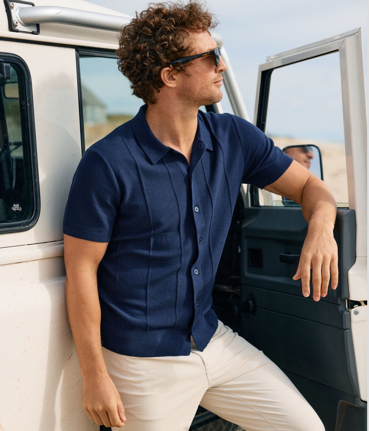 Man outside wearing the Navy Ashe Short Sleeve.