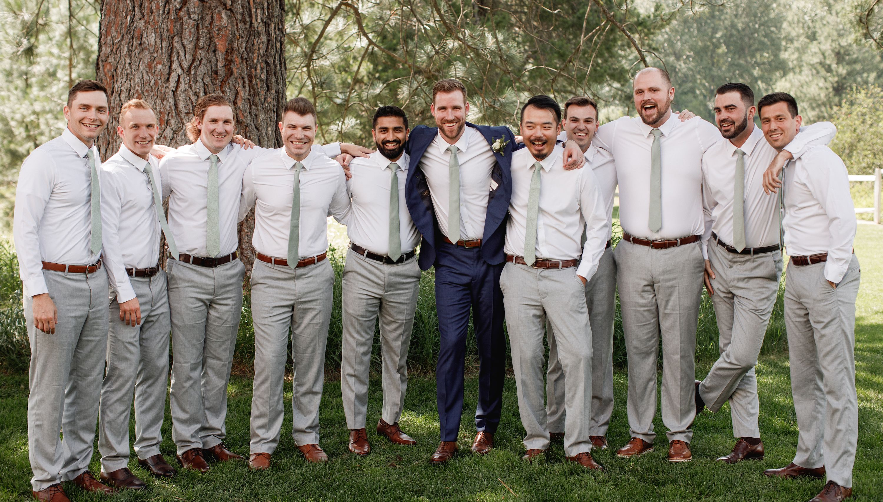 Groom standing in the middle of his groomsmen