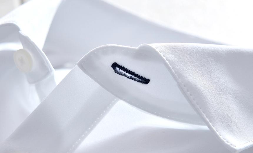 Close up of a white Leeward dress shirt collar and Mizzen+Main's signature navy stitch.