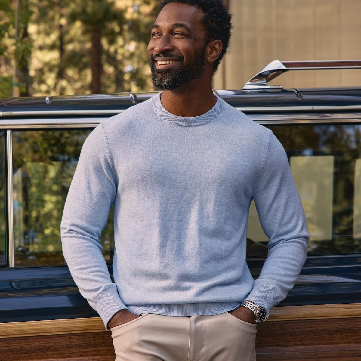 Man relaxing outside wearing the new Heritage sweater.