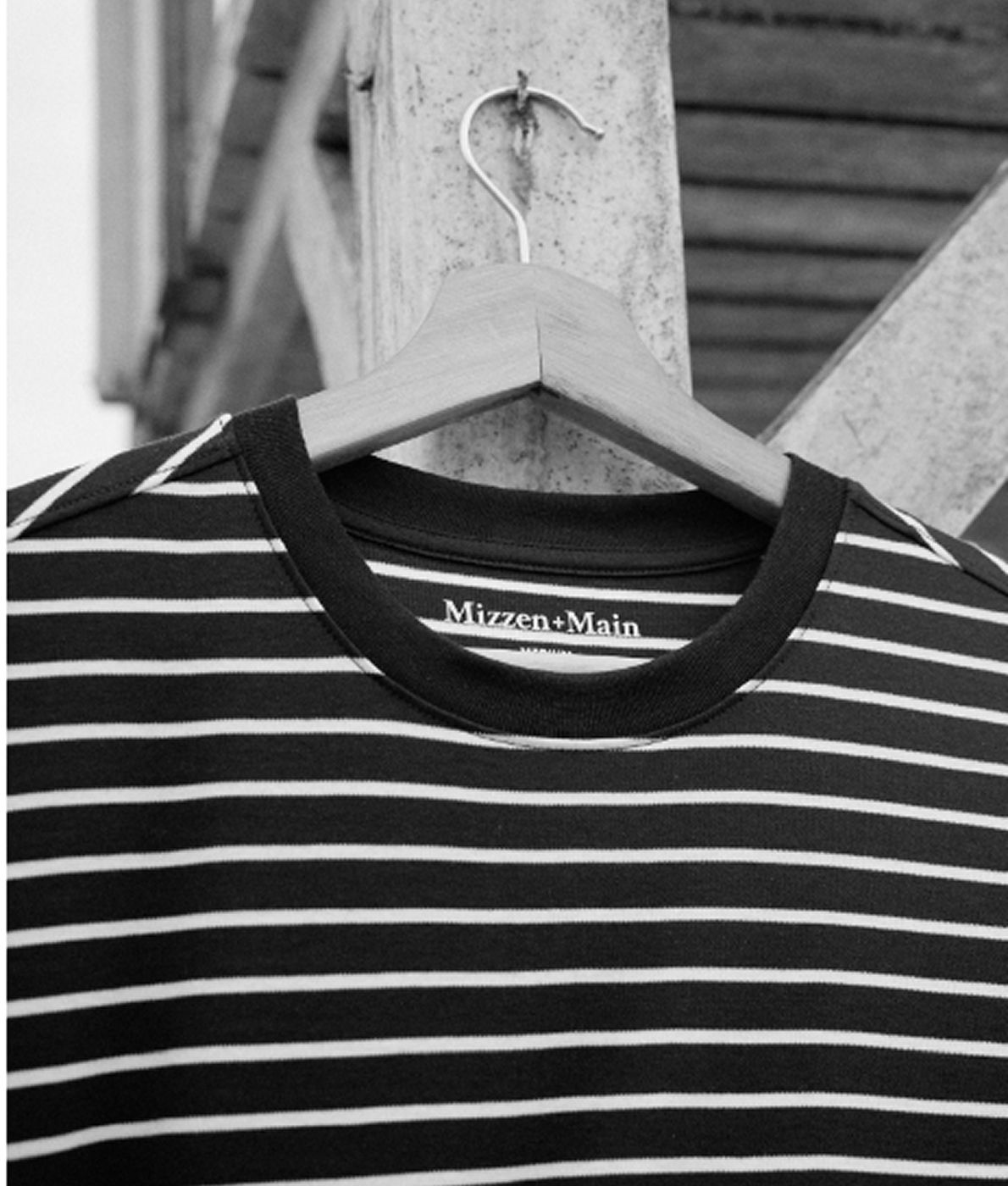 Man outside wearing the Pearl White Navy Stripe Ashe Crewneck Sweater.