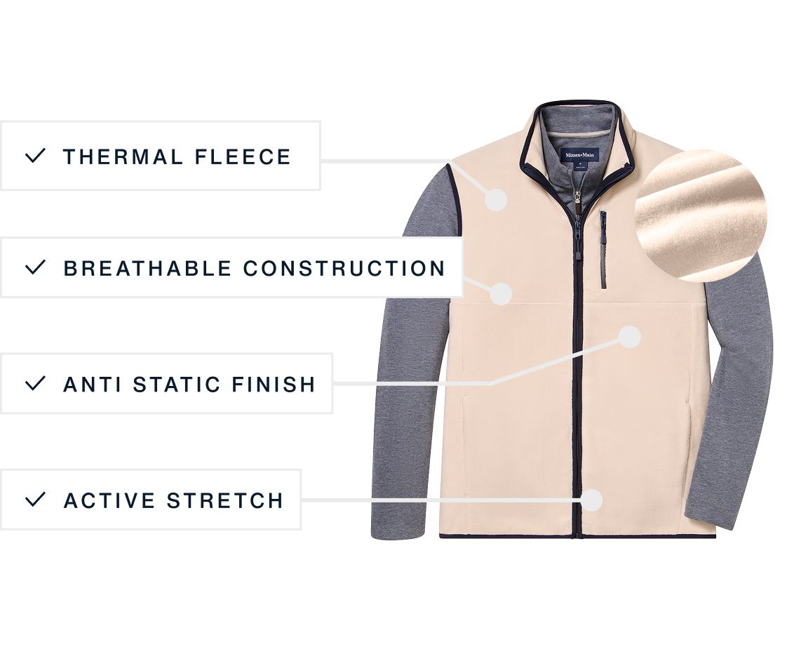 The oat Crosby Fleece Vest laid flat over a gray long-sleeve layer.