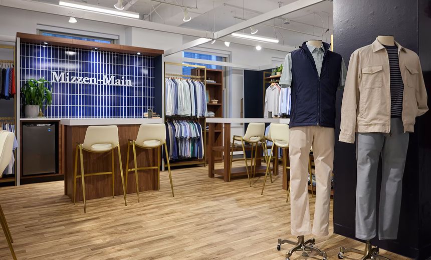 Dress shirts, polos, and outfitted mannequins inside the Mizzen+Main showroom.