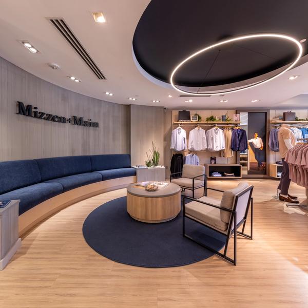 Lounge with a curved blue banquette inside the Mizzen+Main Southlake Town Square store