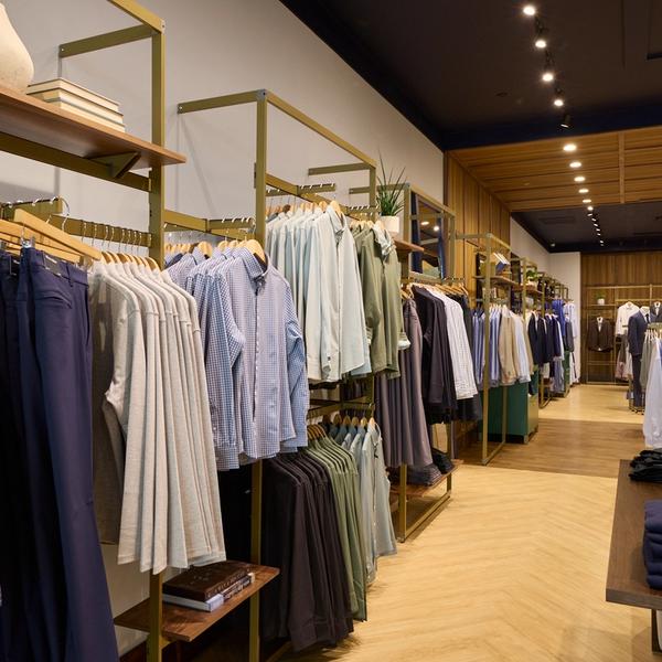 Interior of the Mizzen+Main SouthPark store with racks of dress shirts and folded pants
