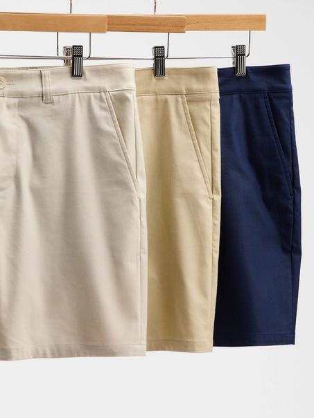 Three Prescott shorts on wooden hangers in stone, khaki and navy