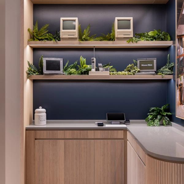 Checkout nook with retro computers and greenery on shelves in the Mizzen+Main Southlake Town Square store