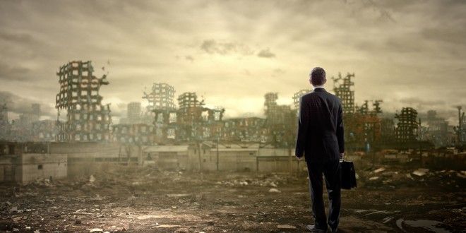 worker looking at post ruins of office building
