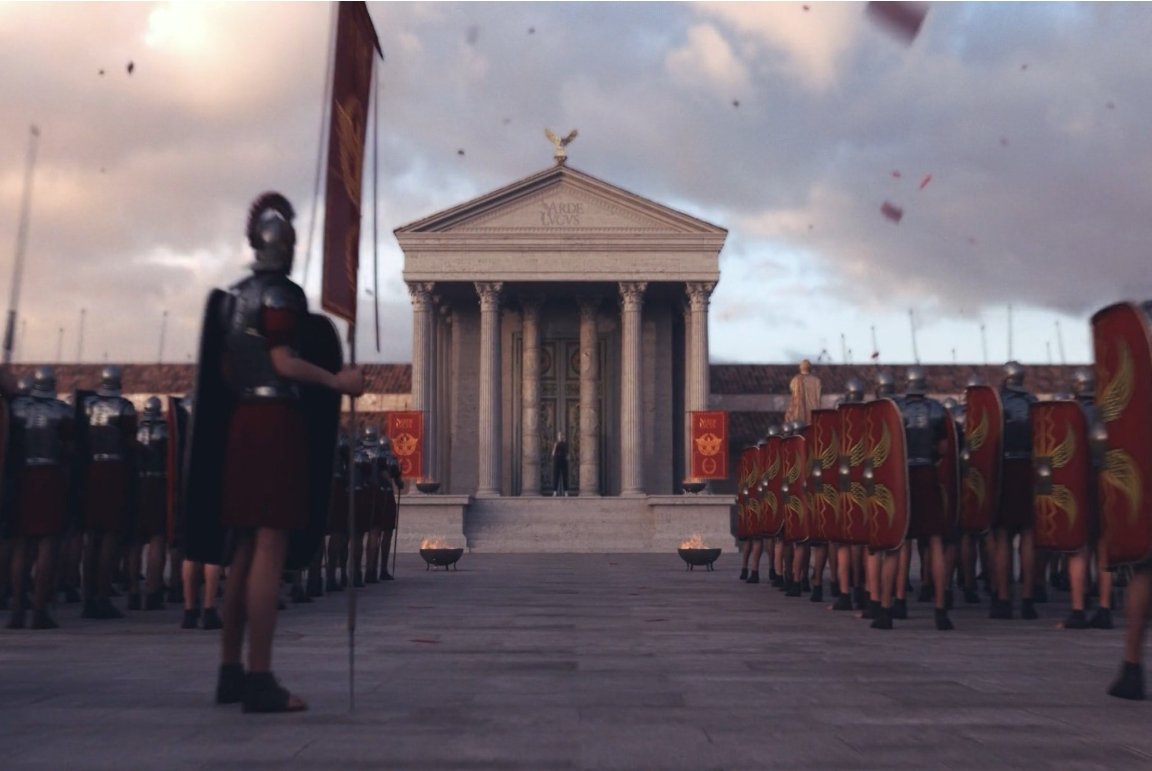 Escena del spot de Arde Lucus 2022 con una formación de legionarios romanos frente a un templo de inspiración clásica, portando estandartes y escudos bajo un cielo cubierto.